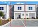 Modern two-story townhome with stone and white exterior at 368 Famagusta Dr, Davenport, FL 33896