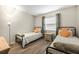 Bright bedroom featuring two twin beds and a nightstand at 3724 S Atlantic Ave # 30, Daytona Beach, FL 32118