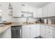 White kitchen with stainless steel appliances and granite countertops at 3724 S Atlantic Ave # 30, Daytona Beach, FL 32118