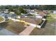 Aerial view of a yellow home with brown roof, a screened-in pool, and white privacy fence at 40 Lantana Dr, Debary, FL 32713