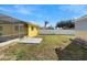 Backyard view showing screened-in porch, detached garage, full, white privacy fence, and partial landscaping at 40 Lantana Dr, Debary, FL 32713