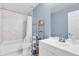 Clean bathroom with bathtub, toilet and shelving at 413 Country Cottage Ln, Winter Garden, FL 34787