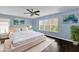 Light and airy primary bedroom with lots of natural light and dark floors creates a cozy space at 413 Country Cottage Ln, Winter Garden, FL 34787
