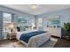 Stylishly decorated bedroom with blue accents and ample natural light at 413 Country Cottage Ln, Winter Garden, FL 34787