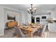 Stylish dining area with modern table set and view of the kitchen at 413 Country Cottage Ln, Winter Garden, FL 34787