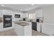 Modern kitchen with white cabinets, granite island, and stainless steel appliances at 413 Country Cottage Ln, Winter Garden, FL 34787