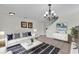 Bright living room featuring a stylish white sofa, modern decor, and a chic rug at 413 Country Cottage Ln, Winter Garden, FL 34787
