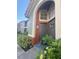 Inviting condo entrance with landscaping and a charming brown door at 429 Fountainhead Cir # 122, Kissimmee, FL 34741