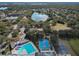 Aerial view of community amenities including pool, basketball courts, and a lake at 4409 Prairie Ct # A, Orlando, FL 32808