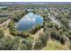 Aerial view showing lake, playground, and surrounding community at 4409 Prairie Ct # A, Orlando, FL 32808