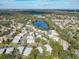 Aerial view of community featuring a lake and numerous homes at 4409 Prairie Ct # A, Orlando, FL 32808