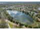 Aerial view of community with lake, mature trees and residential homes at 4409 Prairie Ct # A, Orlando, FL 32808