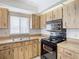 Kitchen with wood cabinets, and modern appliances at 4409 Prairie Ct # A, Orlando, FL 32808