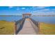 Wooden pier extending to gazebo over lake at 4708 Tribute Trl, Kissimmee, FL 34746