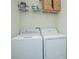 Laundry room with washer, dryer, and overhead shelving at 4708 Tribute Trl, Kissimmee, FL 34746