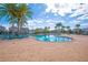 Community pool with surrounding lounge chairs at 4708 Tribute Trl, Kissimmee, FL 34746