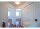 Upstairs hallway with wood floors and doors to bedrooms at 4712 Hemingway House St, Kissimmee, FL 34746