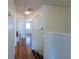 Upstairs hallway with wood floors and doors to bedrooms at 4712 Hemingway House St, Kissimmee, FL 34746