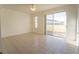 Living room with sliding glass doors leading to a patio at 4712 Hemingway House St, Kissimmee, FL 34746