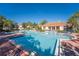 Community pool with lounge chairs at 4712 Hemingway House St, Kissimmee, FL 34746