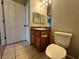 Bathroom with toilet, sink, and wood vanity at 4865 Cypress Woods Dr # 2109, Orlando, FL 32811