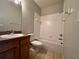 Bathroom with tub, toilet and wood vanity at 4865 Cypress Woods Dr # 2109, Orlando, FL 32811