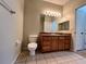 Bathroom with wood vanity, toilet, and tiled floor at 4865 Cypress Woods Dr # 2109, Orlando, FL 32811