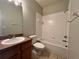 Bathroom with tub, toilet and wood vanity at 4865 Cypress Woods Dr # 2109, Orlando, FL 32811