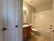 Bathroom with tub, toilet and wood vanity at 4865 Cypress Woods Dr # 2109, Orlando, FL 32811