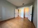 Simple bedroom with tile floors and access to other rooms at 4865 Cypress Woods Dr # 2109, Orlando, FL 32811