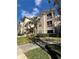 Front view of condo building showcasing landscaping and building features at 4865 Cypress Woods Dr # 2109, Orlando, FL 32811