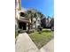 Condo building with palm trees and landscaped grounds at 4865 Cypress Woods Dr # 2109, Orlando, FL 32811