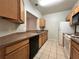 Modern kitchen featuring wood cabinets and stainless steel appliances at 4865 Cypress Woods Dr # 2109, Orlando, FL 32811