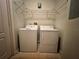 Laundry closet with washer, dryer, and overhead shelving at 4865 Cypress Woods Dr # 2109, Orlando, FL 32811