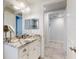 Bright bathroom featuring a granite vanity, and views into the shower and hallway at 5 Riverwalk Dr # 301, New Smyrna Beach, FL 32169