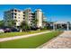 A well-maintained bocce ball court next to a parking lot and recreation pavilion with a sunny sky in the background at 5 Riverwalk Dr # 301, New Smyrna Beach, FL 32169