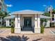 Inviting community clubhouse entrance with a covered walkway, lush tropical plants, and designated parking at 5 Riverwalk Dr # 301, New Smyrna Beach, FL 32169