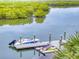 View of private boat dock for residents with space for boat and kayaks at 5 Riverwalk Dr # 301, New Smyrna Beach, FL 32169