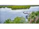 Scenic view of private boat dock with boat and mangrove views at 5 Riverwalk Dr # 301, New Smyrna Beach, FL 32169