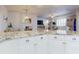 Close-up of the kitchen island featuring countertop seating with living space view at 5 Riverwalk Dr # 301, New Smyrna Beach, FL 32169