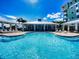 Resort-style pool with lounge chairs and covered cabanas for relaxing in luxury with a clear, sunny sky above at 5 Riverwalk Dr # 301, New Smyrna Beach, FL 32169