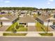 Aerial view of houses with solar panels and landscaped yards at 5372 Palomino Pl, Apopka, FL 32712