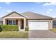 One-story house with tan siding, red shutters, and a white garage door at 5372 Palomino Pl, Apopka, FL 32712