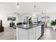 Kitchen with granite countertop island, white cabinets, and stainless steel appliances at 5372 Palomino Pl, Apopka, FL 32712