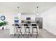 Kitchen with granite countertop, white cabinets, and black barstools at 5372 Palomino Pl, Apopka, FL 32712