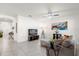 Living room with beige couch, large artwork, and ceiling fan at 5372 Palomino Pl, Apopka, FL 32712