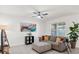 Living room with a neutral color scheme, a comfy couch and large window at 5372 Palomino Pl, Apopka, FL 32712