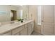 Modern bathroom with double vanity and a large mirror at 5452 Misty Oak Cir, Davenport, FL 33837