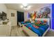 bedroom with twin beds and Marvel character bedding and wall mural at 5452 Misty Oak Cir, Davenport, FL 33837