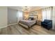 Main bedroom with king-size bed and calming decor at 5452 Misty Oak Cir, Davenport, FL 33837